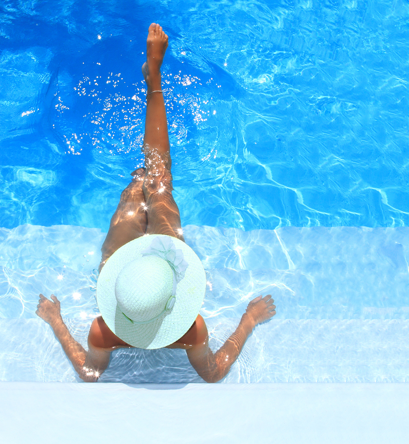 Pretty blonde woman enjoying a swimming pool in Greece